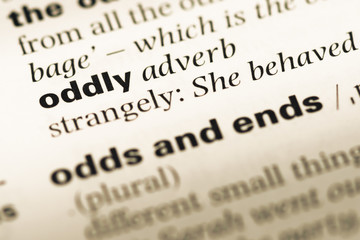 Fototapeta premium Close up of old English dictionary page with word oddly