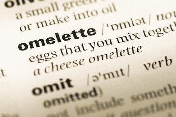 Close up of old English dictionary page with word omelette