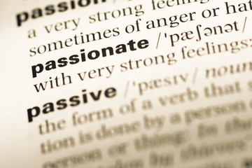 Close up of old English dictionary page with word passionate