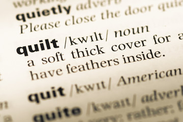 Fototapeta premium Close up of old English dictionary page with word quilt