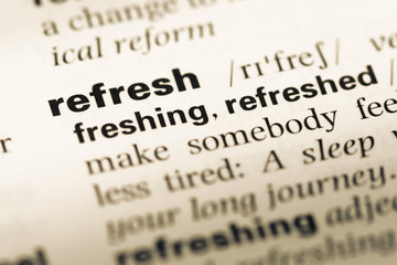 Close up of old English dictionary page with word refresh