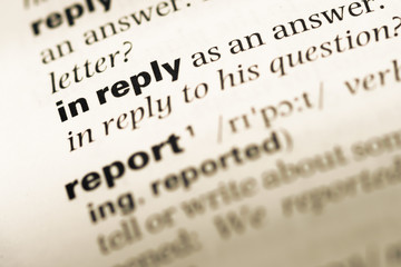 Close up of old English dictionary page with word in reply
