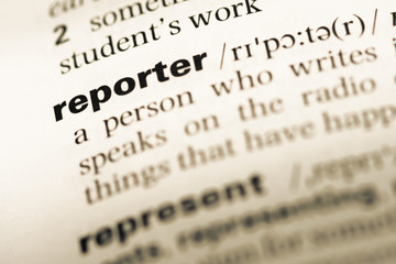 Close up of old English dictionary page with word reporter