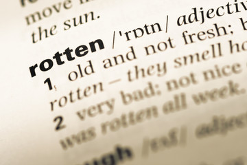 Fototapeta premium Close up of old English dictionary page with word rotten