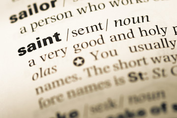 Close up of old English dictionary page with word saint