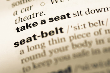 Fototapeta premium Close up of old English dictionary page with word take a seat