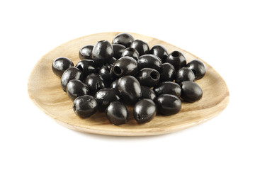 wooden plate with black olives