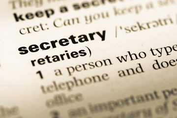 Close up of old English dictionary page with word secretary