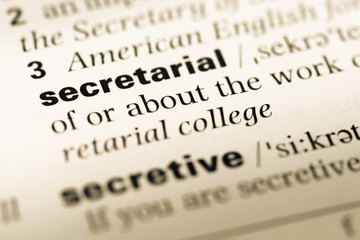 Close up of old English dictionary page with word secretarial