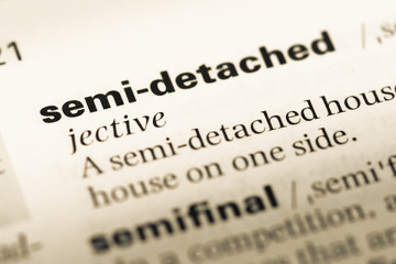 Close up of old English dictionary page with word semi detached