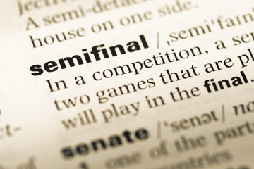 Fototapeta premium Close up of old English dictionary page with word semifinal