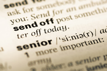 Close up of old English dictionary page with word send off
