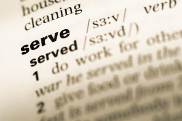 Close up of old English dictionary page with word serve
