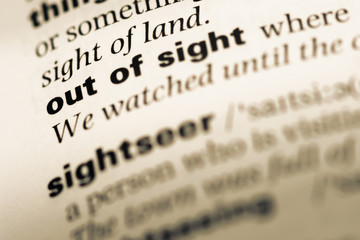 Close up of old English dictionary page with word out of sight