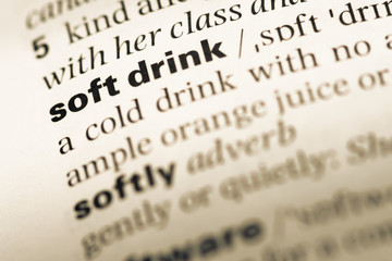 Close up of old English dictionary page with word soft drink