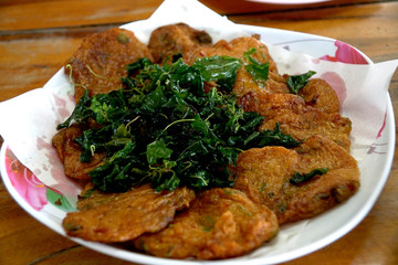 Curried fish and shrimp fritter and fried basil (Thai food)