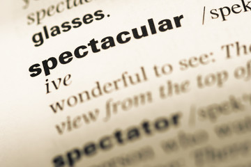 Fototapeta premium Close up of old English dictionary page with word spectacular