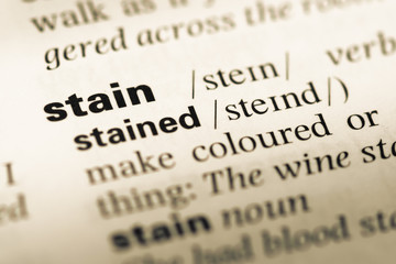 Close up of old English dictionary page with word stain