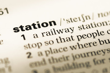 Close up of old English dictionary page with word station