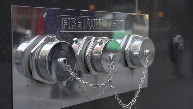 Close up shot of fire pump test outlets on a building.