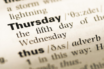 Fototapeta premium Close up of old English dictionary page with word thursday