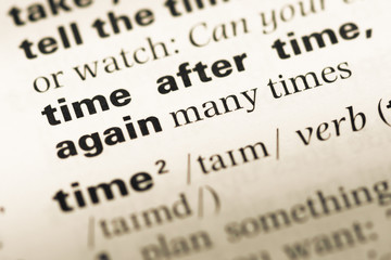 Fototapeta premium Close up of old English dictionary page with word time after tim