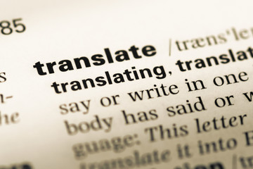 Close up of old English dictionary page with word translate