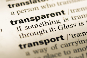 Close up of old English dictionary page with word transparent