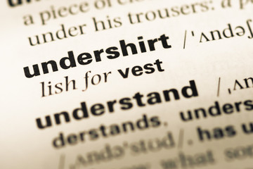 Close up of old English dictionary page with word undershirt