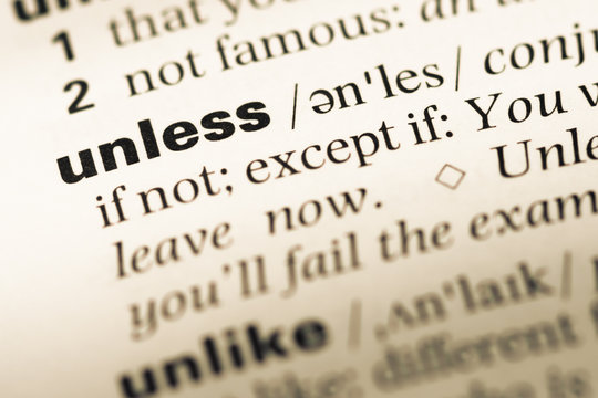 Close up of old English dictionary page with word unless