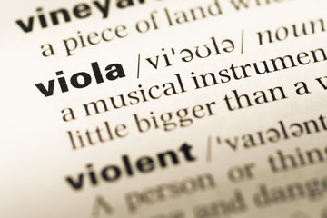 Obraz premium Close up of old English dictionary page with word viola