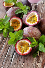 juicy fruit Granadilla with mint on a wooden table
