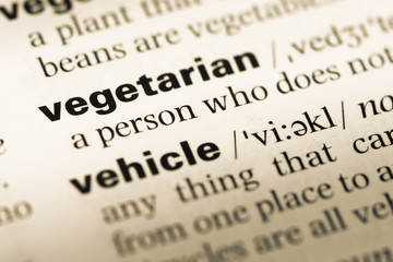 Close up of old English dictionary page with word vegetarian