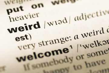 Obraz premium Close up of old English dictionary page with word weird