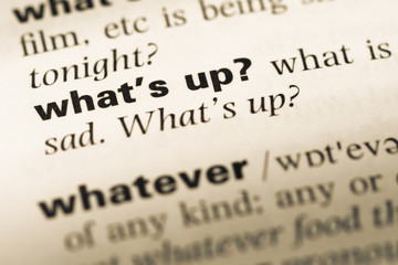Close up of old English dictionary page with word what's up