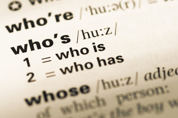 Close up of old English dictionary page with word who's