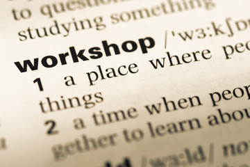 Close up of old English dictionary page with word workshop