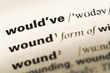 Fototapeta premium Close up of old English dictionary page with word would've