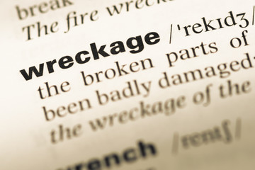 Fototapeta premium Close up of old English dictionary page with word wreckage