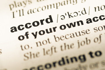 Obraz premium Close up of old English dictionary page with word accord