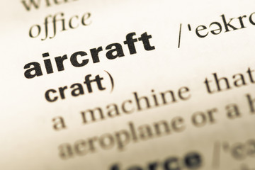 Close up of old English dictionary page with word aircraft
