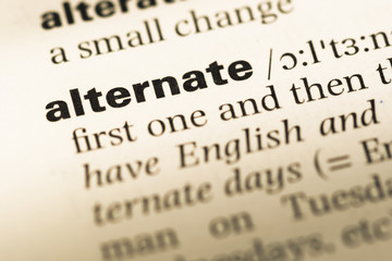 Close up of old English dictionary page with word alternate