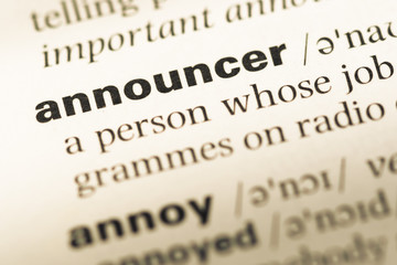 Close up of old English dictionary page with word announcer
