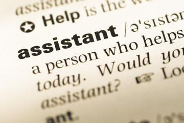 Obraz premium Close up of old English dictionary page with word assistant