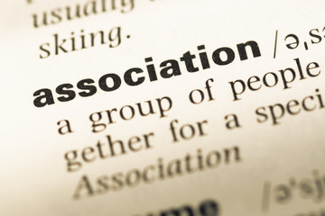 Obraz premium Close up of old English dictionary page with word association