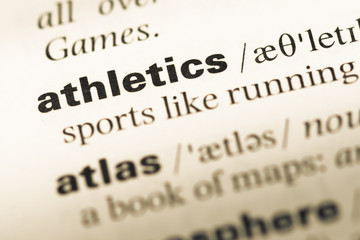 Fototapeta premium Close up of old English dictionary page with word athletics