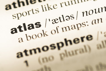 Close up of old English dictionary page with word atlas