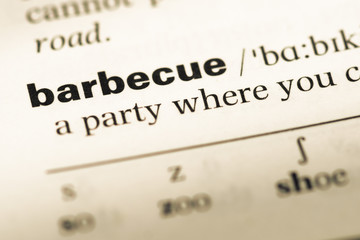 Close up of old English dictionary page with word barbecue