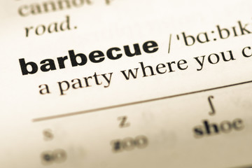 Obraz premium Close up of old English dictionary page with word barbecue