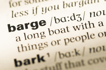 Obraz premium Close up of old English dictionary page with word barge